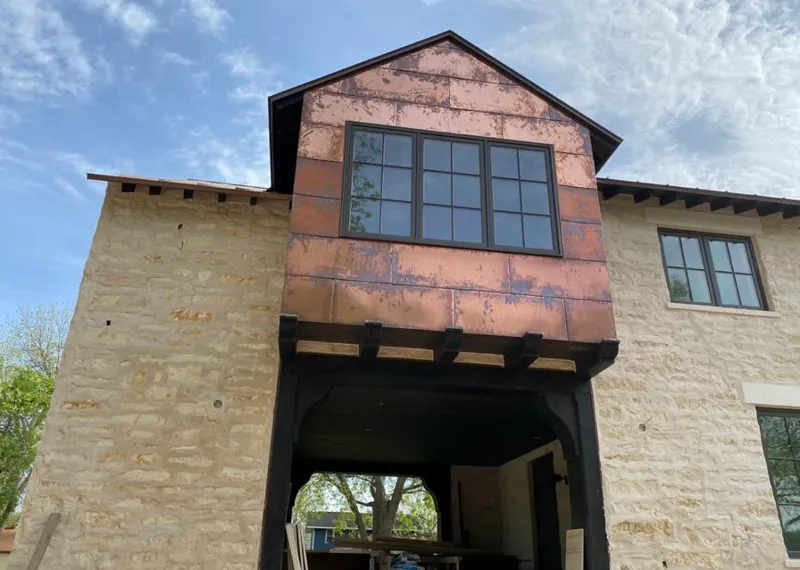 Copper metal panel facade on a stone building for Skylight Installation in Colts Neck